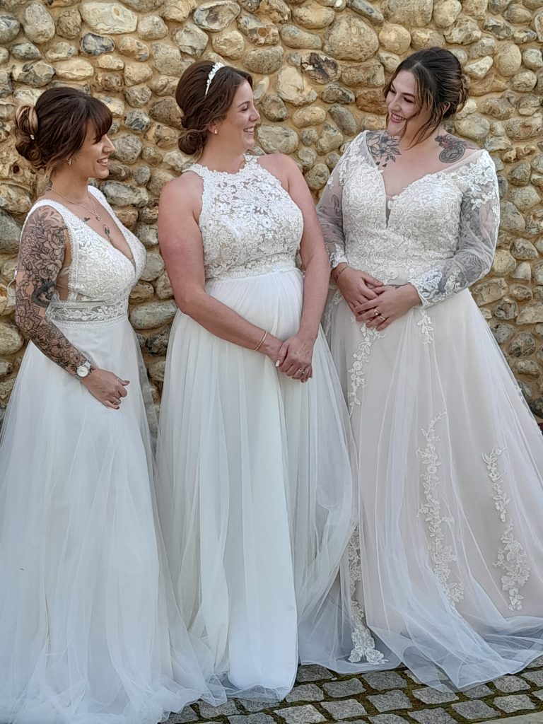 Three brides modelling wedding dresses