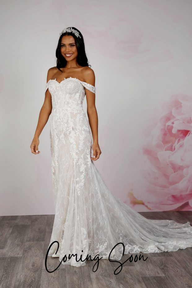 This photo shows a bride wearing an allover lace fit and flare wedding dress by Emma Bridals. BL369 features a sweetheart neckline with detachable off-the-shoulder lace straps, and a gorgeous train with lace edging over a layer of textured tulle. 