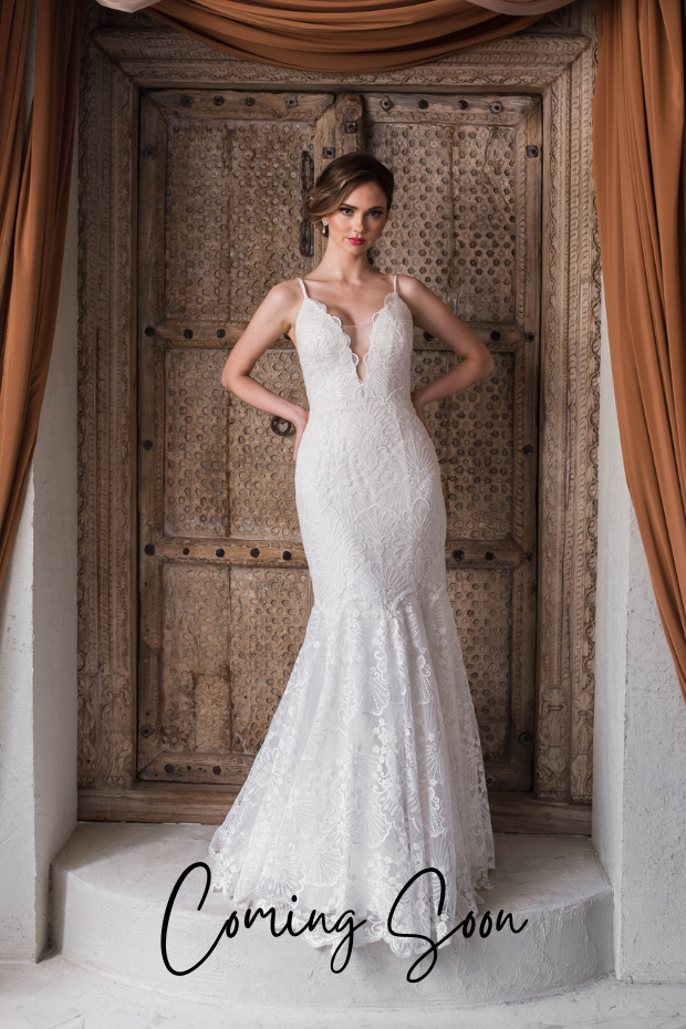 Photo shows a bride wearing a lace mermaid wedding dress by Purple Fox. Daylight features a low plunge neckline and beaded spaghetti straps.