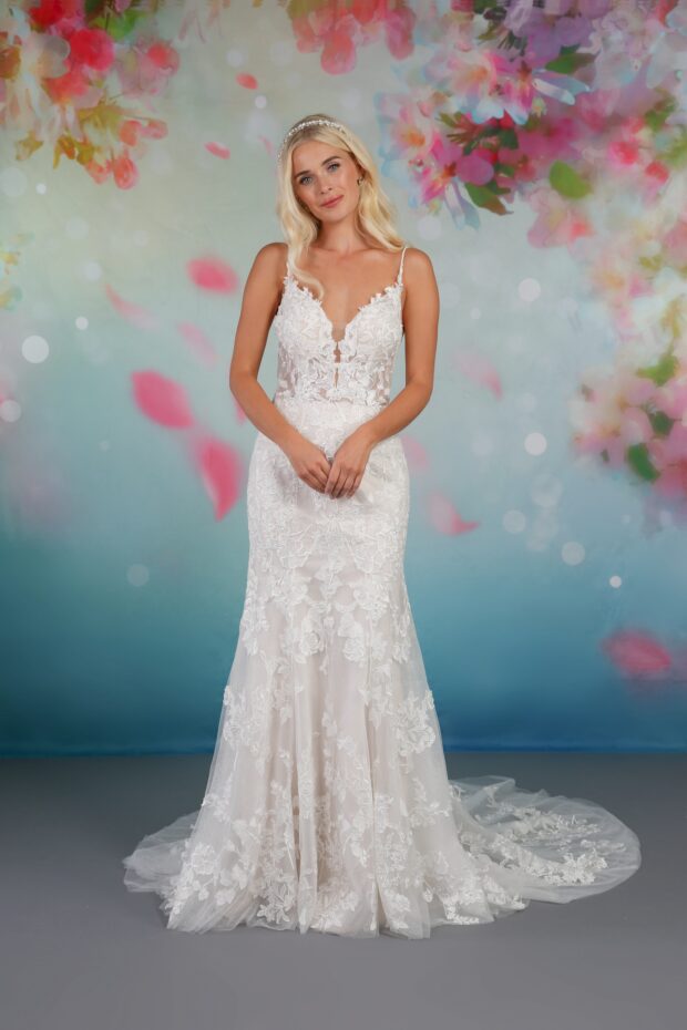BL330 by Emma Bridals is a beautiful blooming floral lace glitter bridal gown with a plunging V-neckline, and beaded straps. The extra sparkly glitter runs throughout the dress and statement lace train, finished with romantic rose lace detailing. Secured at the back with a zip.