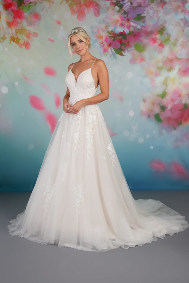 BL323 is a gorgeous ivory and champagne wedding dress by Emma Bridals featuring a camisole bodice with low back and sparkly narrow straps. The lace appliques cover the bodice and then become more spaced out over the tulle skirt.