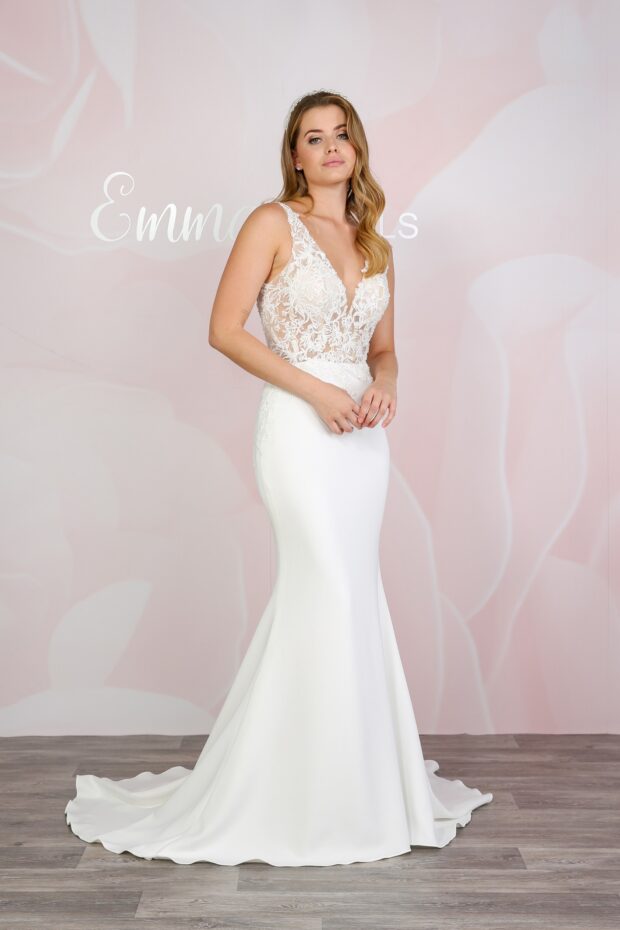 Photo shows model wearing bridal gown BL423 which features a v-neck lace bodice and plain ivory jersey fit and flare skirt.