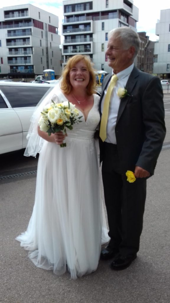 Photo of one of our real Lucky Sixpence brides with her new husband.