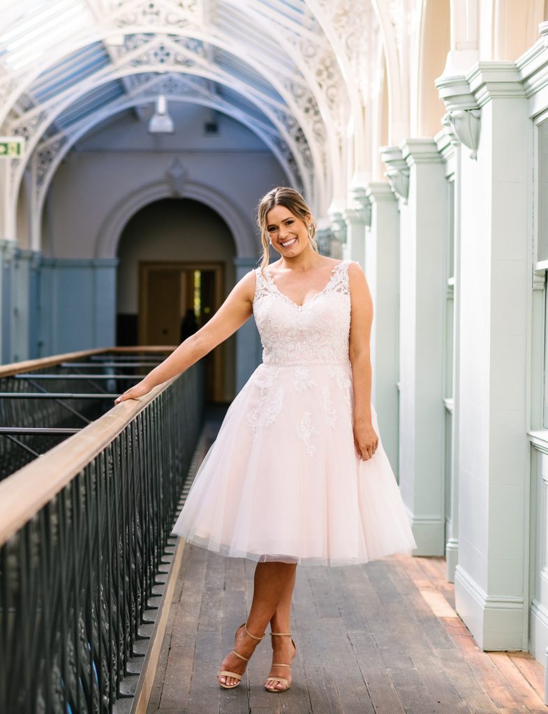 Bride wearing a lace and tulle tea length wedding dress "Tiffany" by Gilded Rose