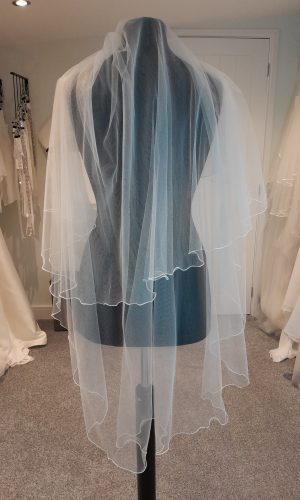 S194 veil by Bianco Evento. Veil is two-tier with a corded edge.