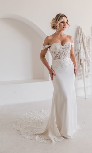 Lucky Sixpence Bridal product, Mystery Train. A fit-and-flare bridal gown with lace bodice and off-the-shoulder straps. The plain crepe skirt finishes with a lace train.